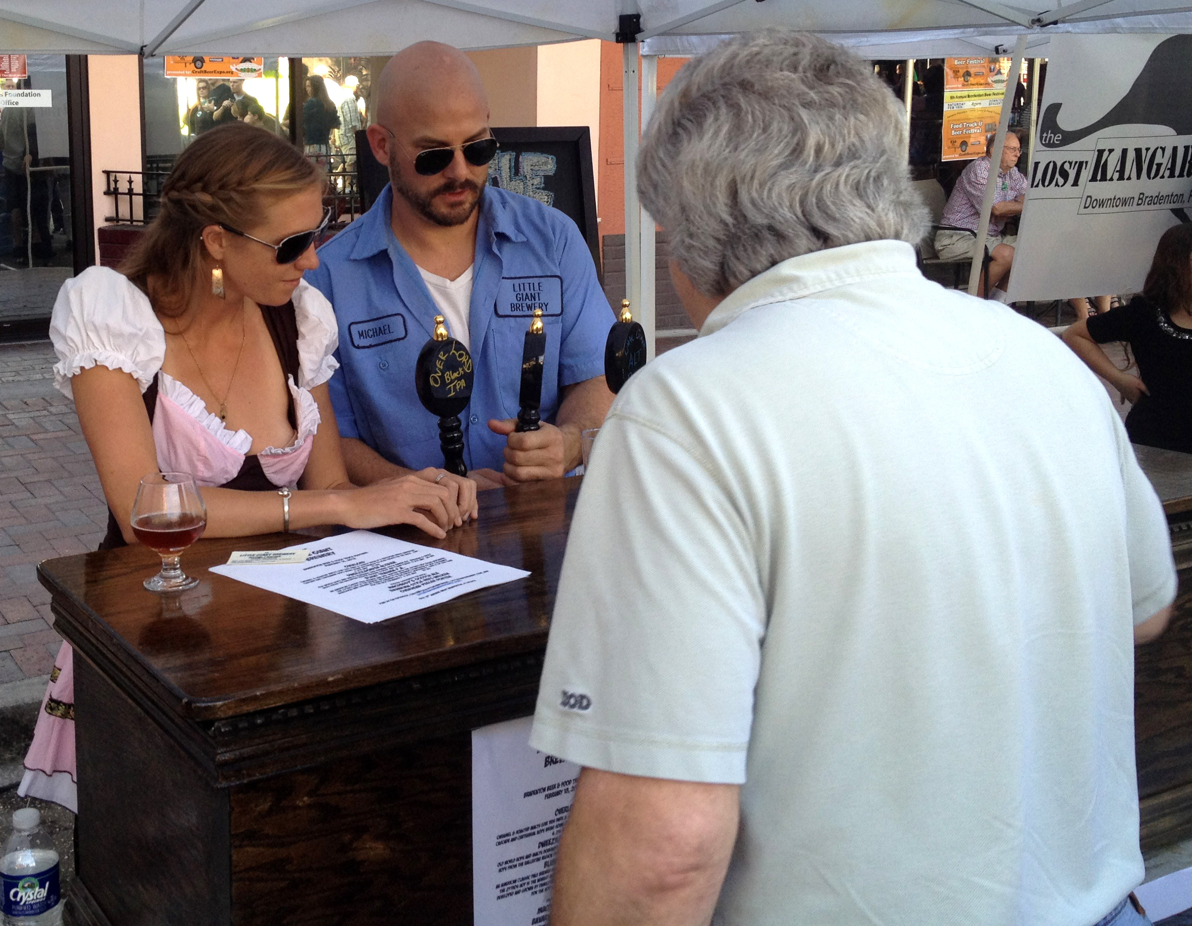 Shanell Ryan and Little Giant Brewery brewmaster Michael Wagner serve his beers at the Bradenton Beer Festival Feb. 18 in downtown Bradenton. (Staff photo / Alan Shaw)
