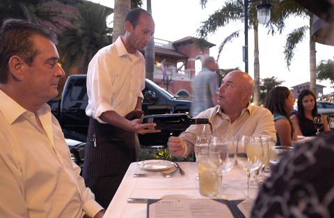 Stephen Moy,35, a server at Libby's Cafe and Bar pours wine for customers. (Herald-Tribune Staff Photo by Thomas Bender)