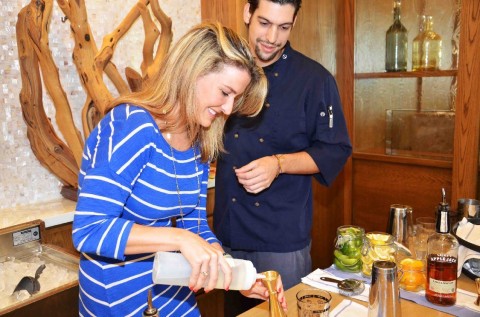 Roy Roig, Jack Dusty's head mixologist, invites a lovely assistant behind the bar at a recent review of the restaurant's summer mixology series. Photo by InstudioE.