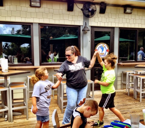 Crystal Steele, Road Captain of the Diva Angels' Pasco Chapter, dances with her daughters to music from Scott Curts.