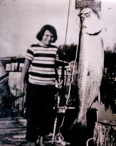 Marian Schneider at age 11, shows off a 125-pound tarpon she caught while fishing with her father in Boca Grande. The photo is one of Schneider's prized possessions. (Herald-Tribune archive)