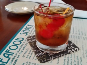 Bartender Nick Field makes a stiff, tasty Manhattan at the Seafood Shack in Cortez. STAFF PHOTO / WADE TATANGELO